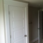 New cross-paneled door with custom trim to match existing house